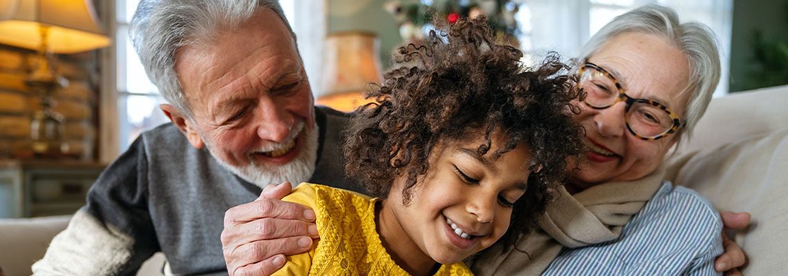 Happy child with grandparents at home