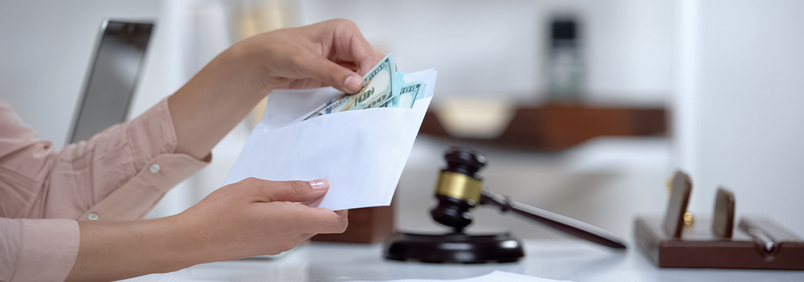 Divorced woman holding envelope with dollars, savings for single mom
