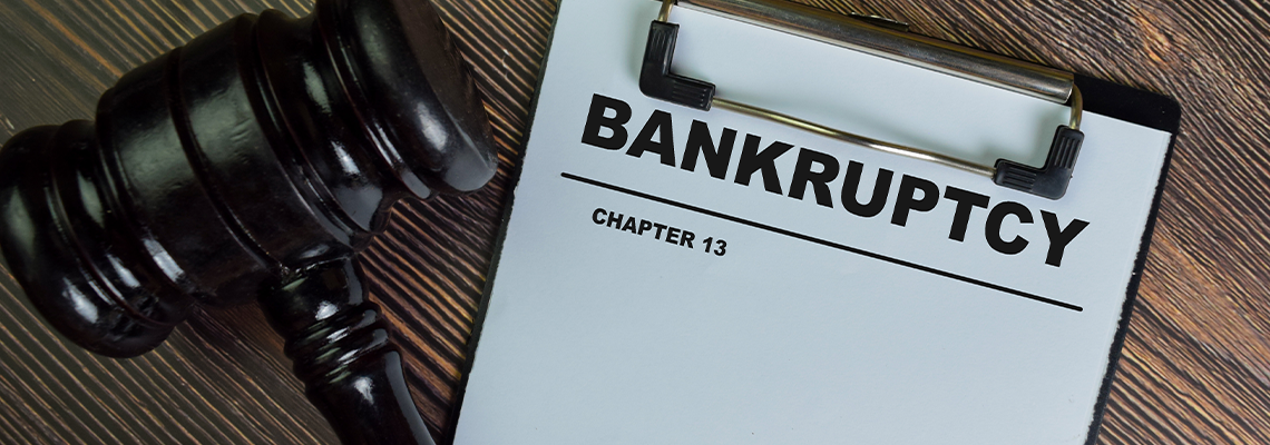 Bankruptcy - Chapter 13 write on a paperwork isolated on Wooden Table