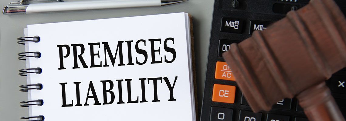 PREMISES LIABILITY words in white notebook with gavel on table