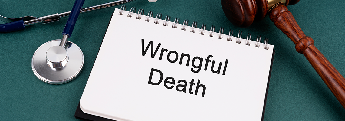 High angle view of Gavel and Wrongful Death text on a Notebook