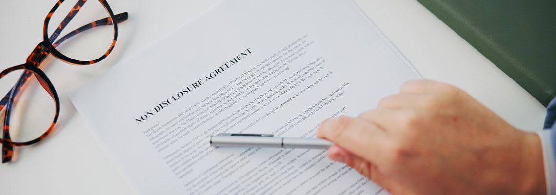 Man reviewing Non-Disclosure Agreement before signing