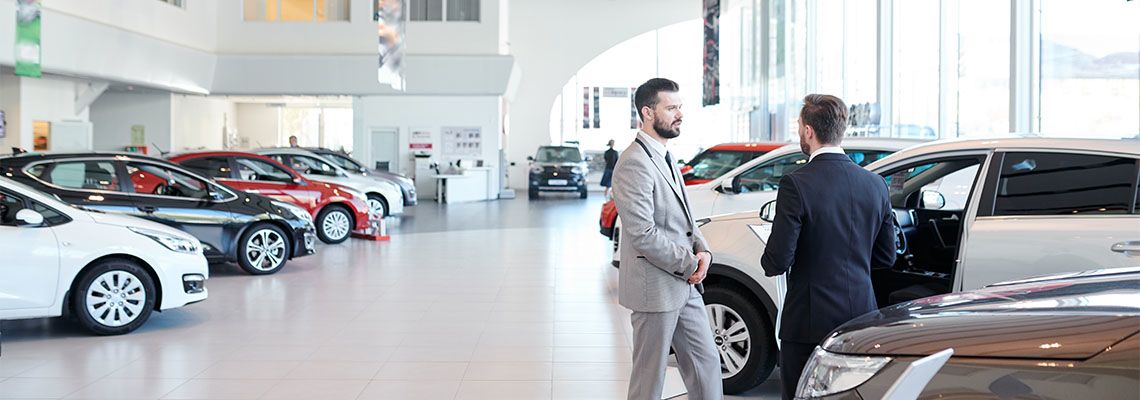 Man looking for a car in car showroom