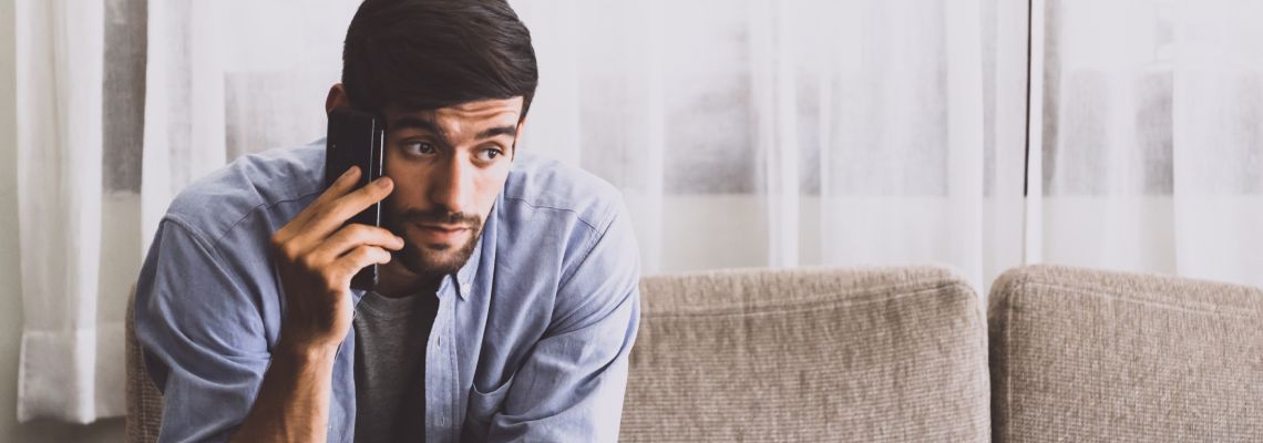 Man with serious expression talking on the phone