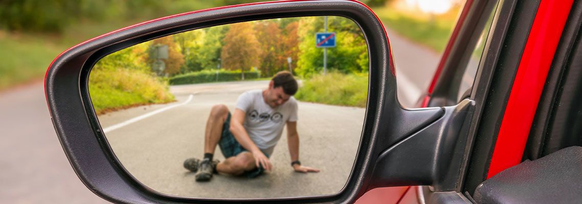Injured man is seen in rear view mirror