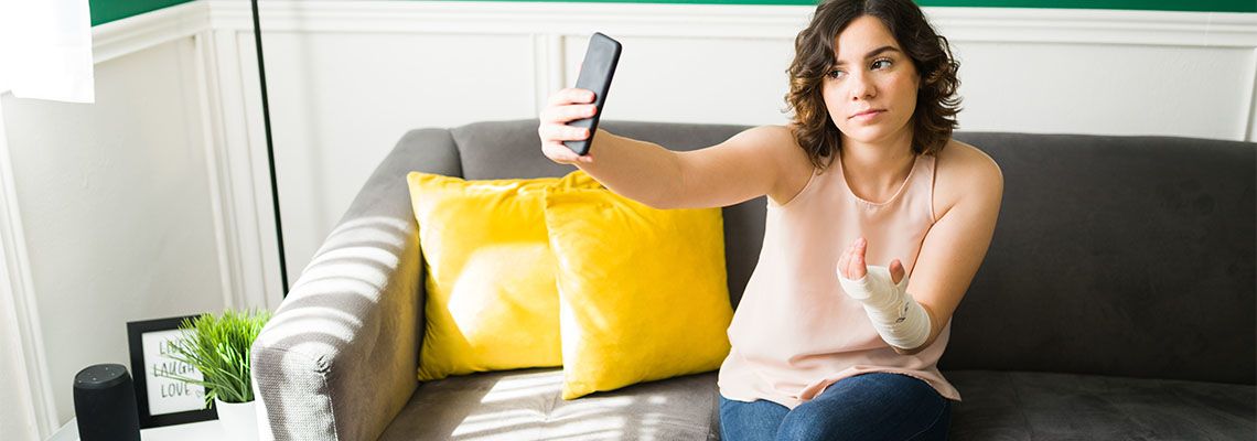 Woman with Injury clicking photo to post in social media