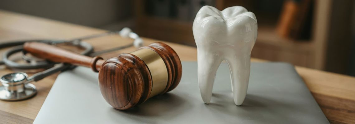 Dental malpractice concept with gavel and tooth