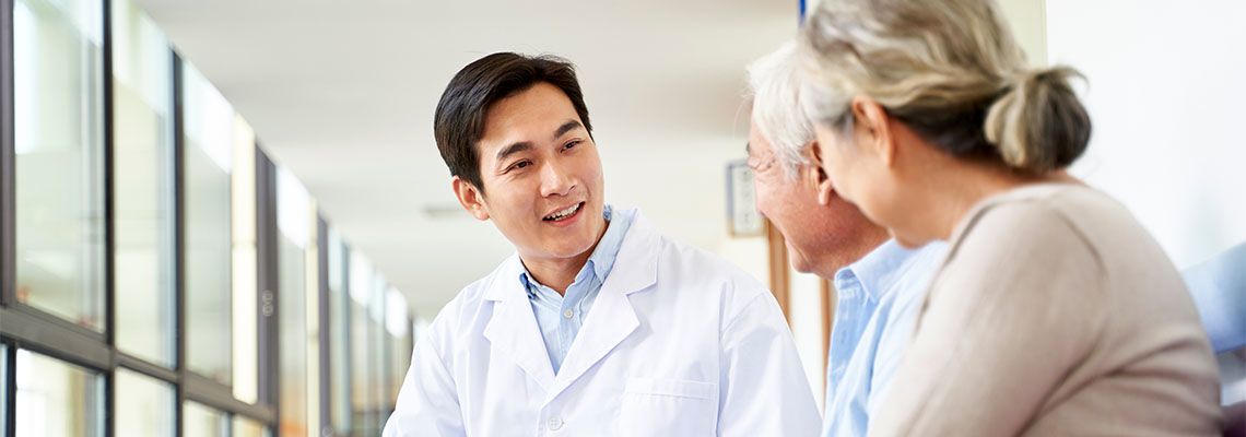 Doctor talking to old patients