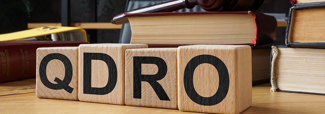 Table and cubes with abbreviation QDRO Qualified Domestic Relations Order
