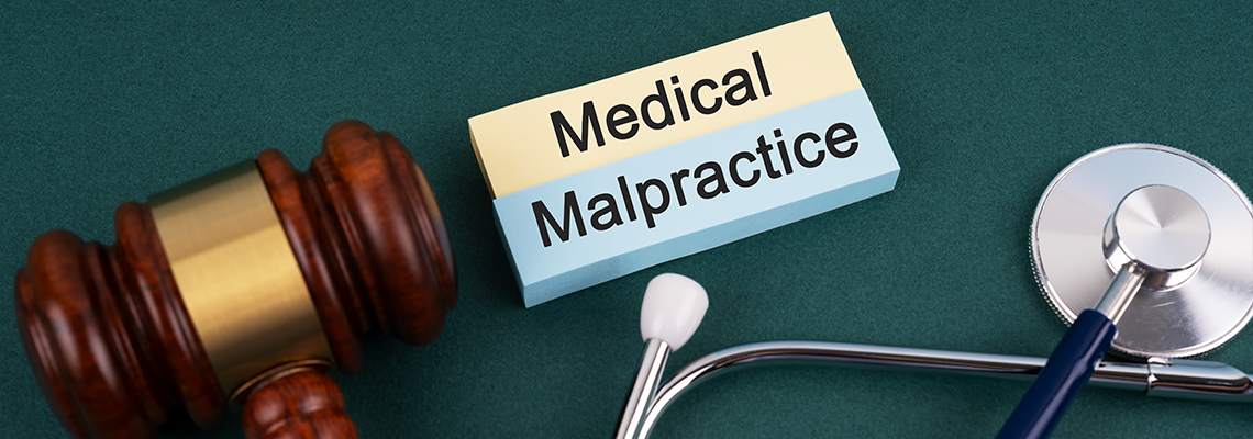 High angle view of gavel and stethoscope Medical Malpractice concept