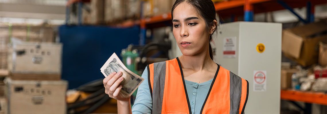 Sad warehouse factory worker women after receiving low cut salary