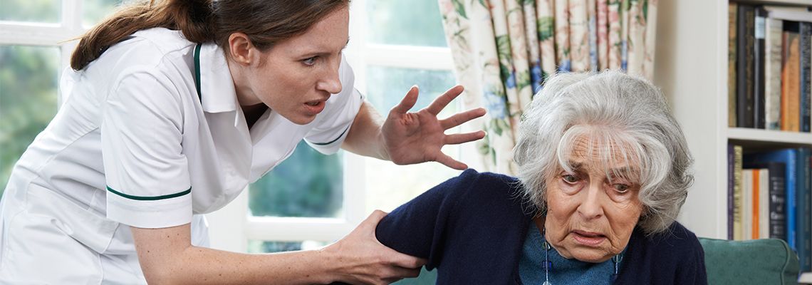 Care giver abusing elderly women in nursing home