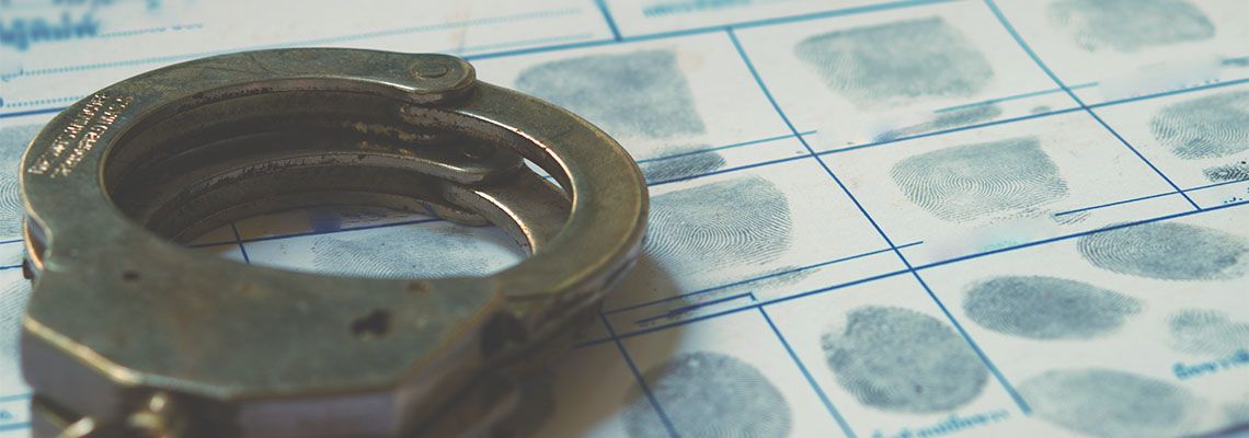 Handcuff and sheet with criminal fingerprint
