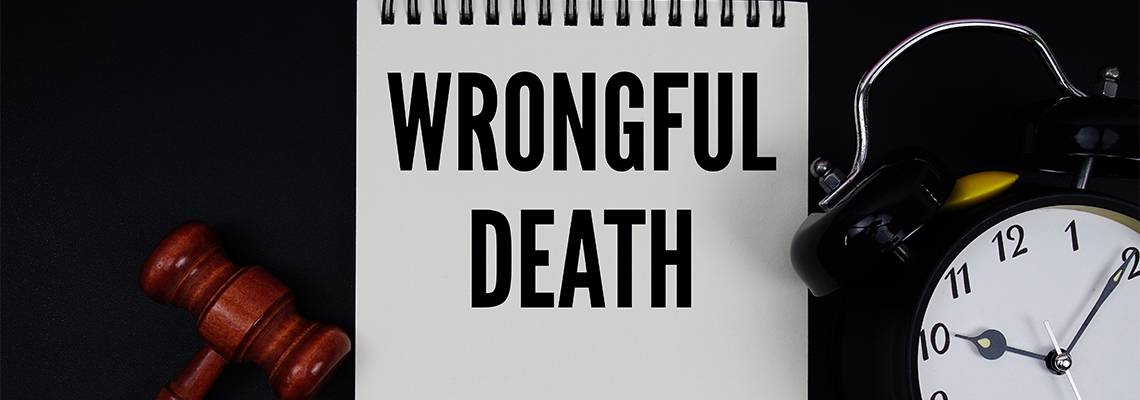 Wrongful Death text written on notepad with gavel and alarm clock