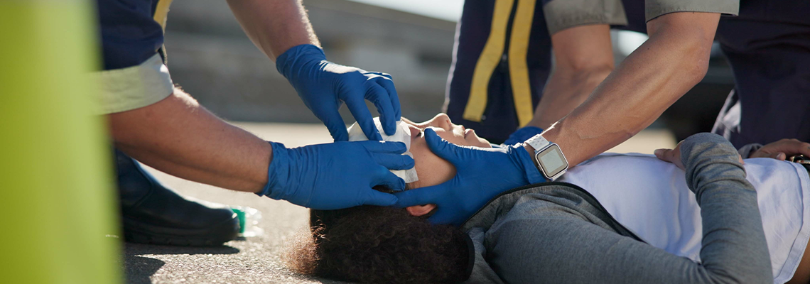 Paramedic, accident and hands on head injury on road in car crash emergency