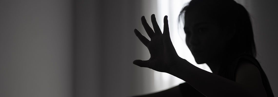 Women showing hands signaling to stop sexual abuse