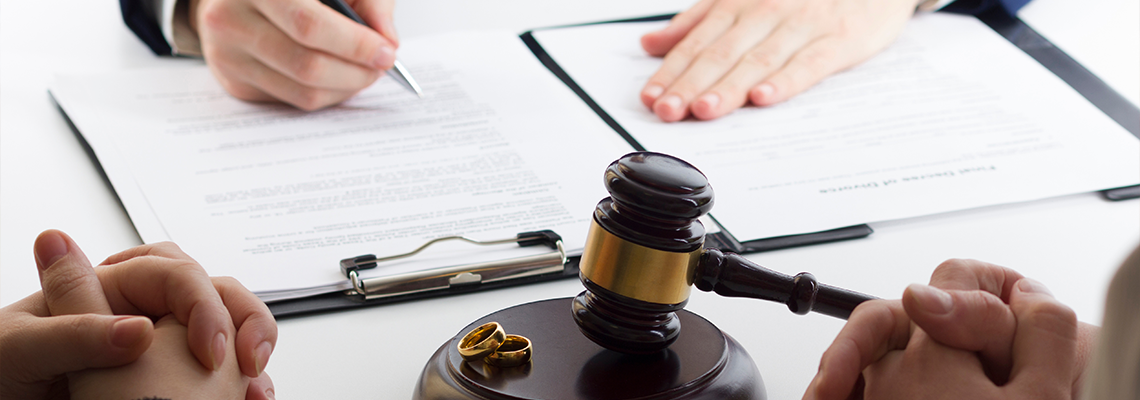 Hands of wife, husband signing decree of divorce, dissolution, canceling marriage