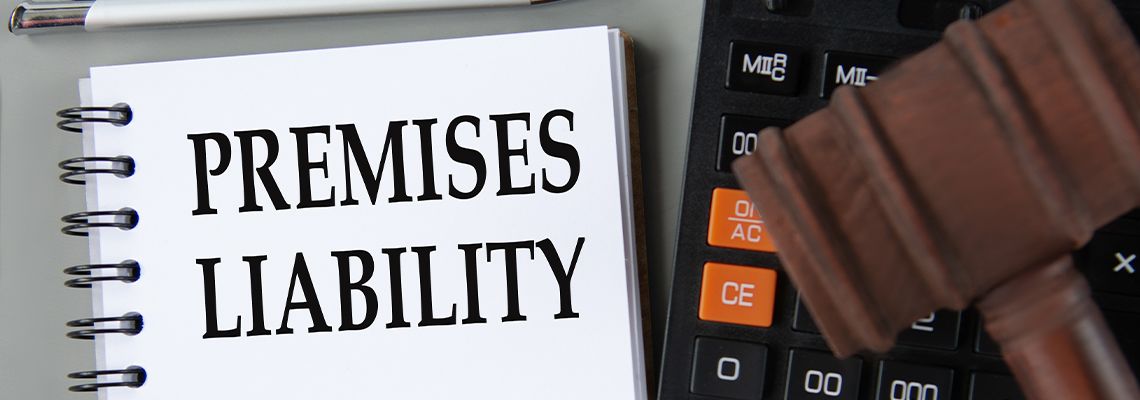 PREMISES LIABILITY words in white notebook with gavel
