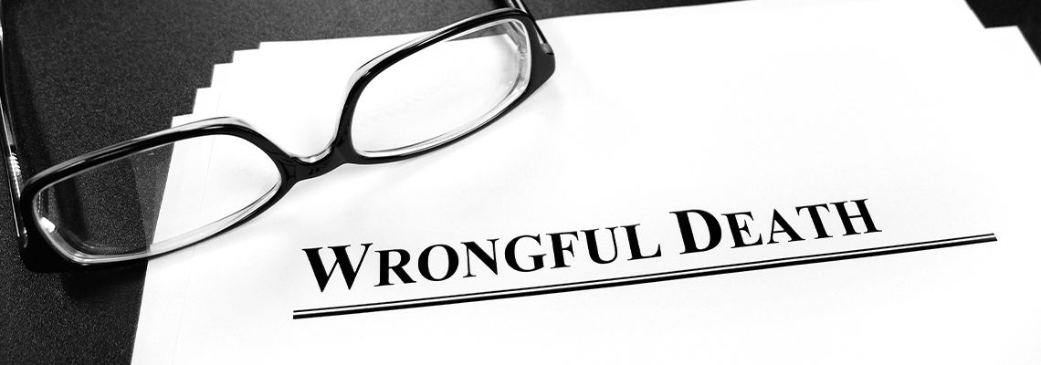 Wrongful Death file on table with glasses