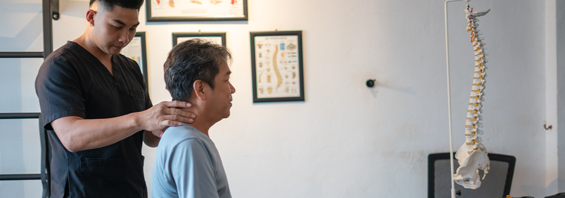 A chiropractor assists a patient in a healing session focusing on spinal health