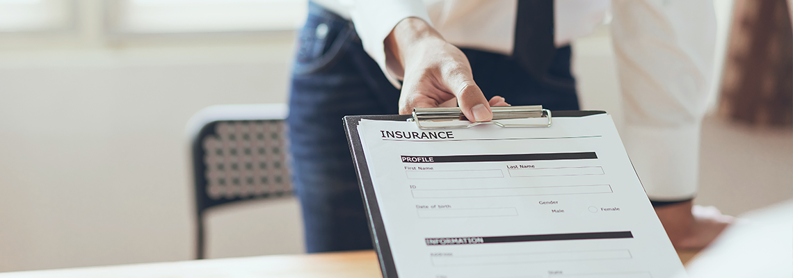 Business man in the office fill out insurance policy with client