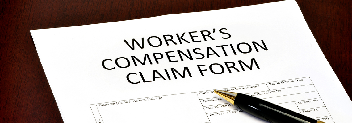Worker Compensation Form and Pen on Table