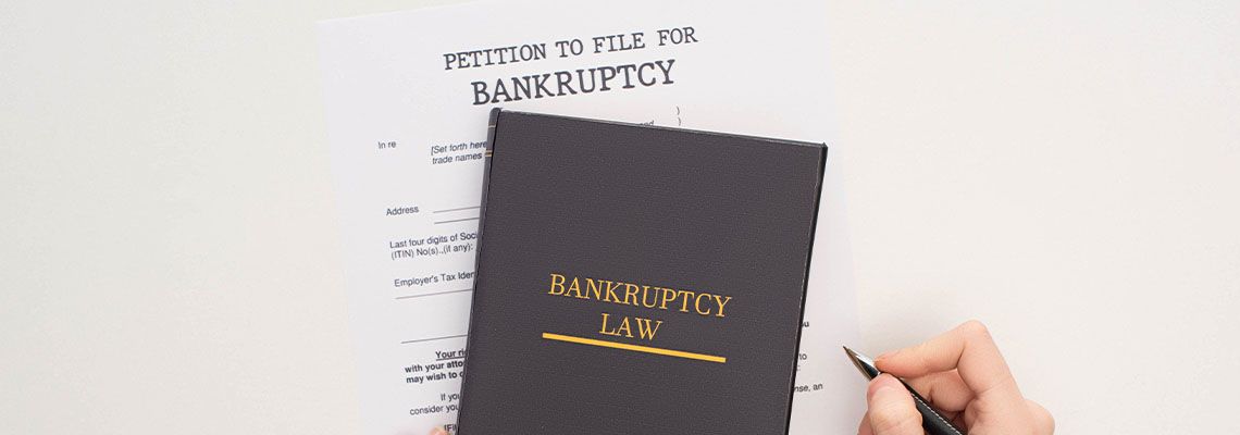Petition to file for Bankruptcy form beneath Bankruptcy Law book