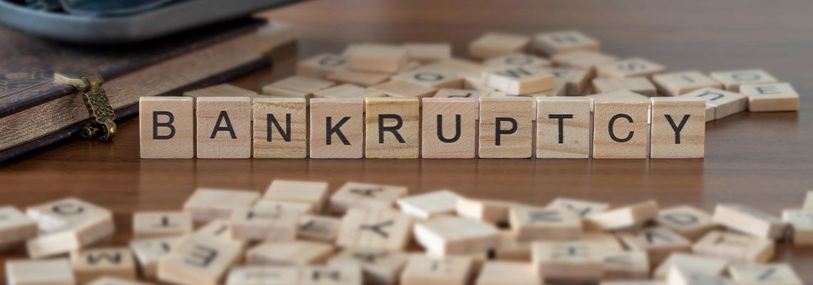 Wooden letter tiles spelling Bankruptcy