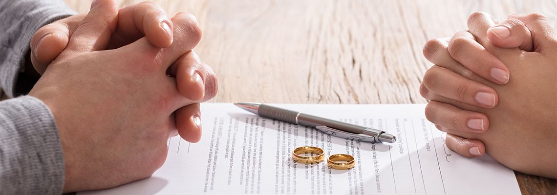 Couple's Hand On Divorce Agreement
