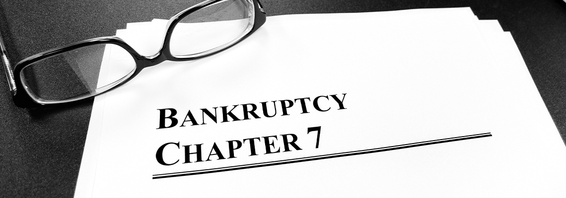 Bankruptcy Chapter 7 Documents on Desk with Glasses