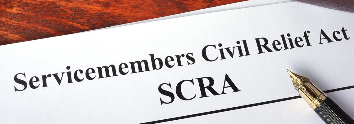Servicemembers Civil Relief Act (SCRA) document and pen in table