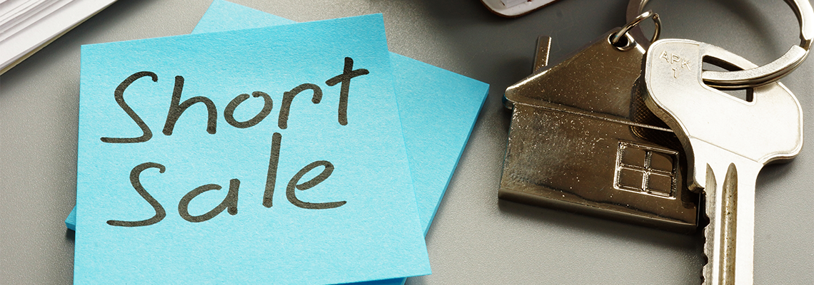 Text sign showing hand written words Short sale and house key