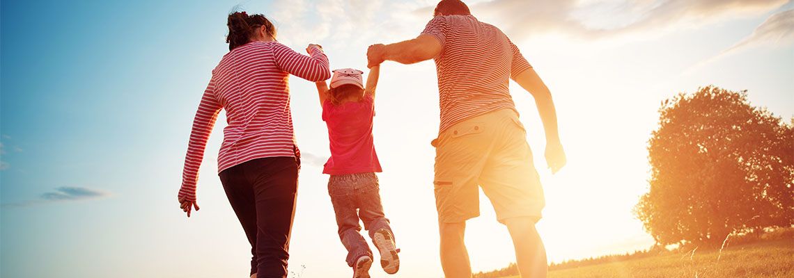 Child with parents outdoors