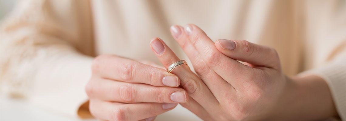 Woman taking off wedding ring
