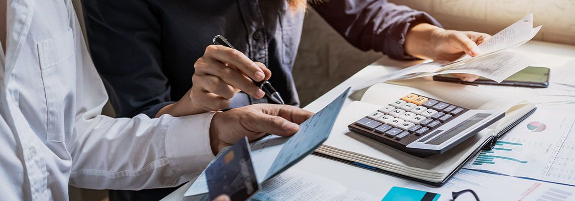 Business partners calculating loans