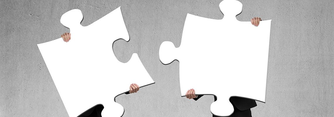 Business partner taking puzzle pieces apart