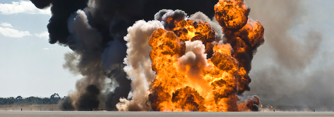 Fiery explosion with thick black smoke on an airport runway