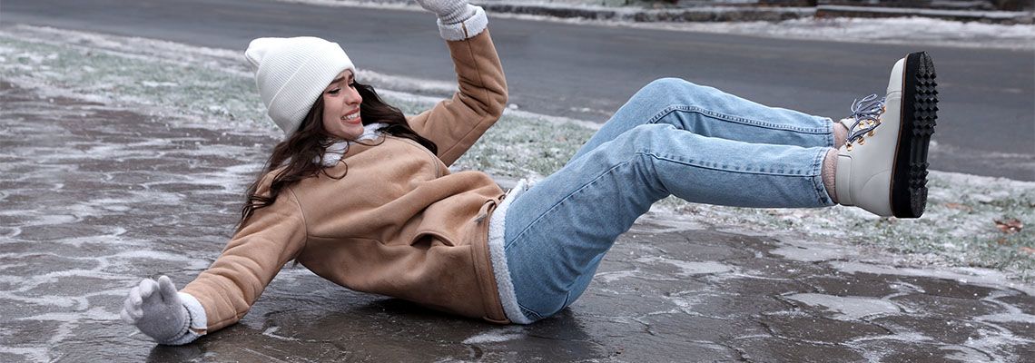 Women slips and fall on icy pavement