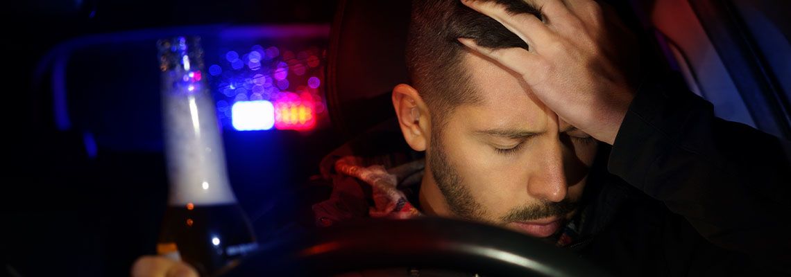 Man drinking beer while driving car pulled over by police