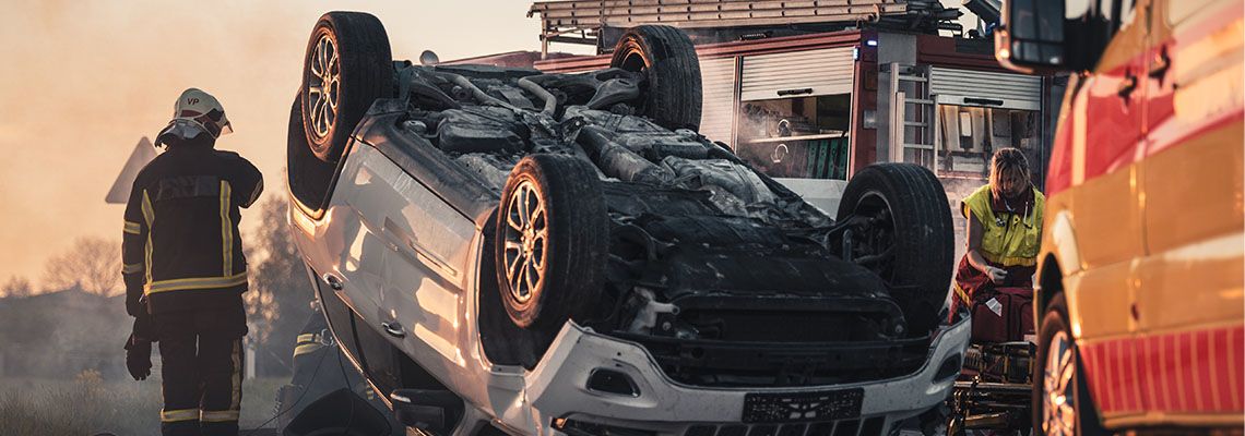 Car Lying on its Roof in the Middle of the Road after Collision