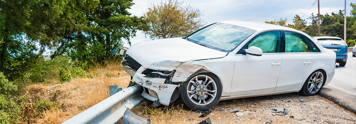 Crashed car with deflated airbags after accident finished on road