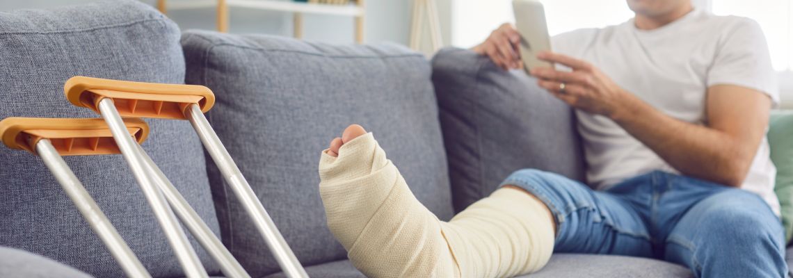 Man with injured leg at home