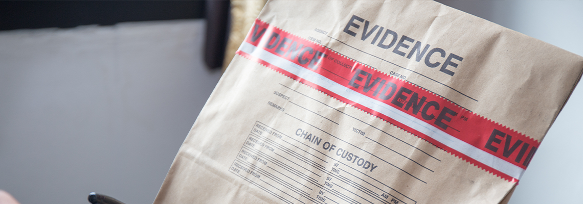 Hand in Glove Writing on Evidence Bag and Seal by Red Tape