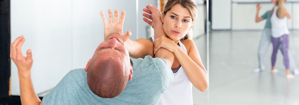 Woman practicing self defense techniques in a class