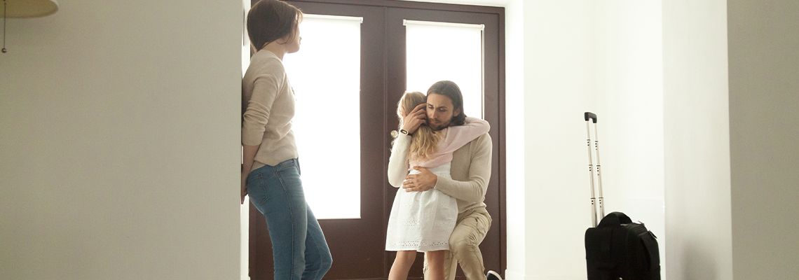 Little Girl Hugs Father who is moving out after divorce