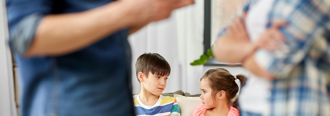 Sad children and arguing parents