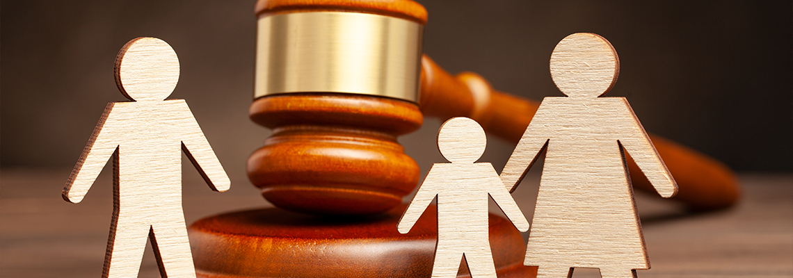 Mother with child apart from father and judge's hammer