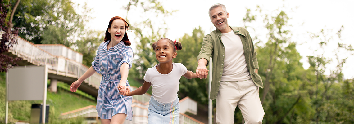 African-American daughter running while walking with parents