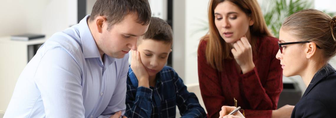Divorced parents with their son visiting lawyer