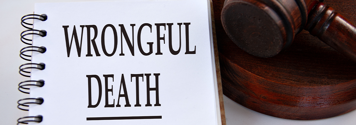 WRONGFUL DEATH - words in a white notebook with a judge's gavel